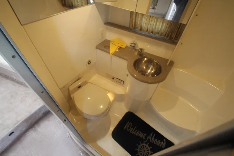 Slide: The Image of Compact bathroom in a 2001 Formula 400 Super Sport boat with sink and toilet. - 22
