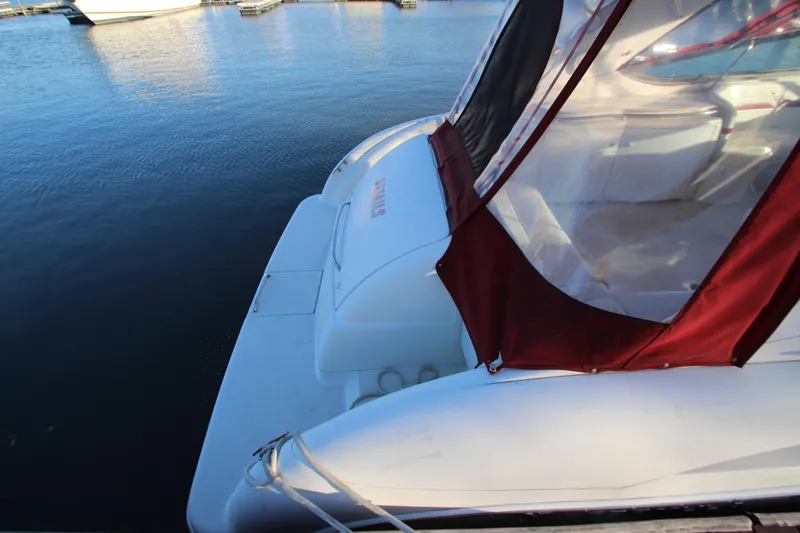 Slide: The Image of 2001 Formula 400 Super Sport boat docked with red canopy, calm water background. - 35