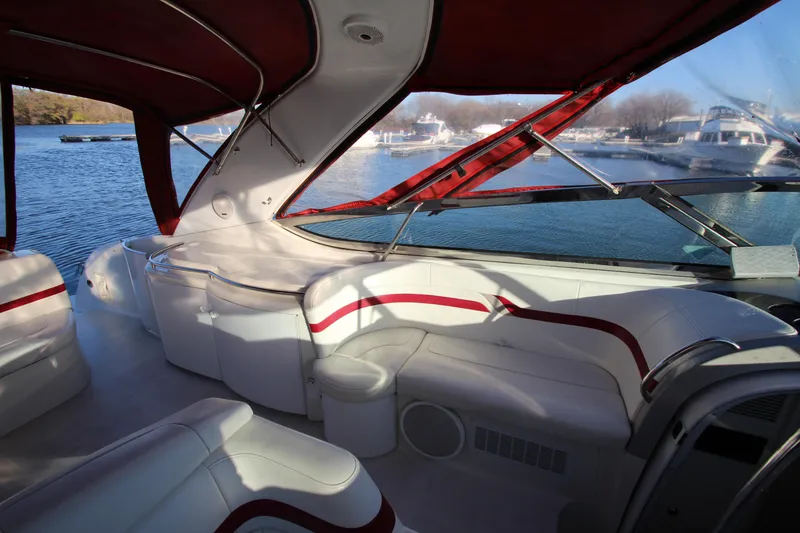 Slide: The Image of 2001 Formula 400 Super Sport boat interior with red and white seating, docked on a sunny day. - 8