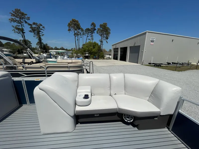 Slide: The Image of 2017 Godfrey 255 Sweetwater Premium pontoon boat with white seating and cup holder. - 19