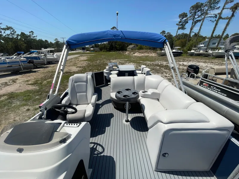 Slide: The Image of 2017 Godfrey 255 Sweetwater Premium pontoon boat with white seating and blue canopy. - 22