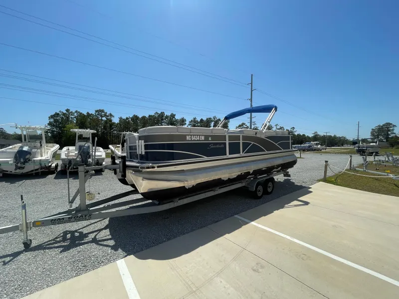 Slide: The Image of 2017 Godfrey 255 Sweetwater Premium pontoon boat on trailer, sunny day, outdoor display. - 3