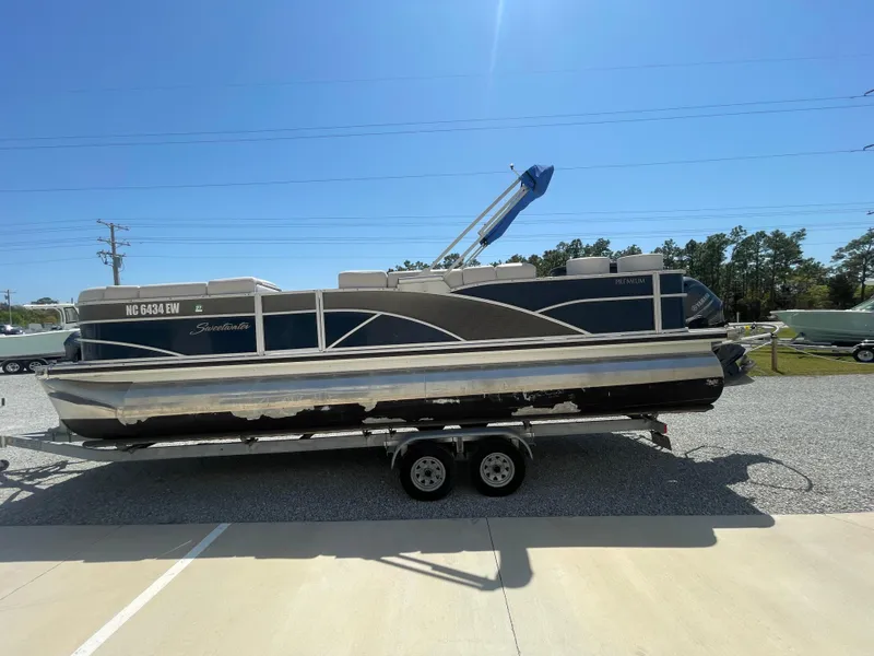 Slide: The Image of 2017 Godfrey 255 Sweetwater Premium pontoon boat on trailer under clear blue sky. - 4