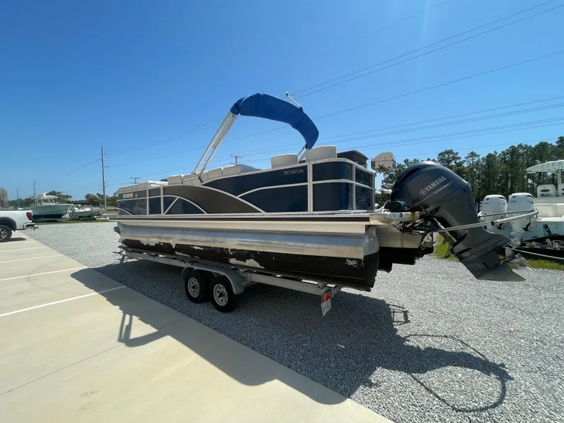 Slide: The Image of 2017 Godfrey 255 Sweetwater Premium pontoon boat on trailer, parked outdoors. - 5