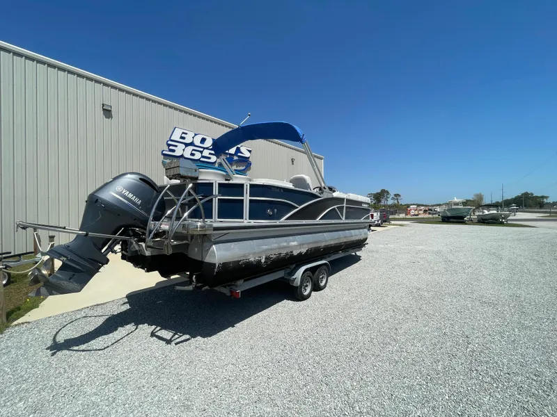 Slide: The Image of 2017 Godfrey 255 Sweetwater Premium pontoon boat on trailer, parked outside a warehouse. - 7