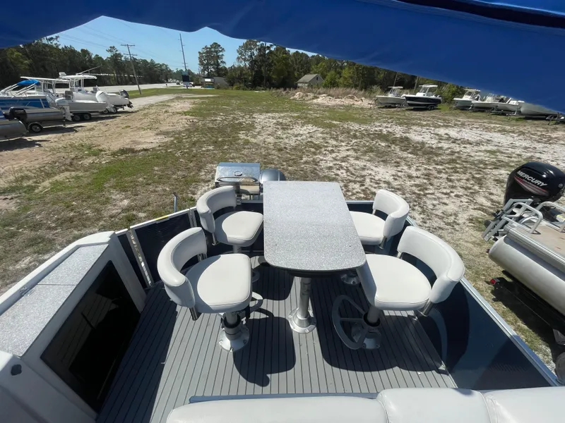 Slide: The Image of 2017 Godfrey 255 Sweetwater Premium boat interior with seating and table setup. - 8