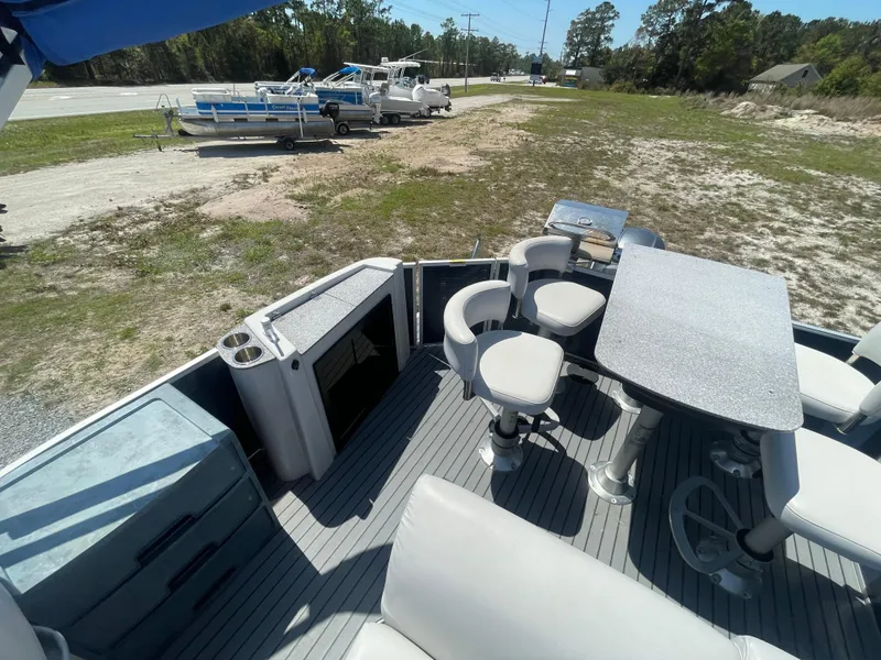 Slide: The Image of 2017 Godfrey 255 Sweetwater Premium pontoon boat interior with seating and table setup. - 9