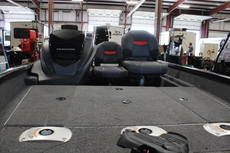 Slide: The Image of 2025 Tracker Pro Team 175 boat interior with seating and storage compartments. - 11
