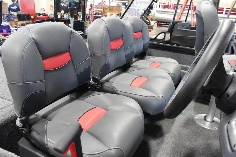 Slide: The Image of 2025 Tracker Pro Team 175 boat interior with gray and red seats. - 13