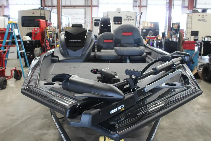 Slide: The Image of 2025 Tracker Pro Team 175 boat in a workshop, featuring Minn Kota trolling motor. - 2