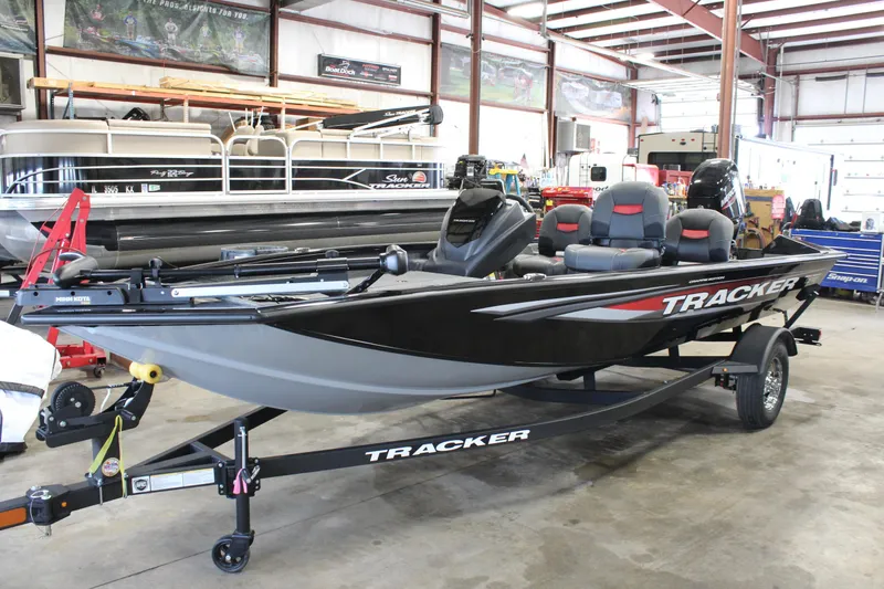 Slide: The Image of 2025 Tracker Pro Team 175 boat in showroom, black with red accents, on trailer. - 3
