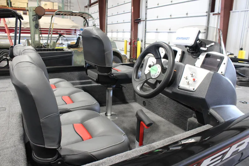 Slide: The Image of 2025 Tracker Pro Team 175 boat interior with steering wheel and seating. - 6