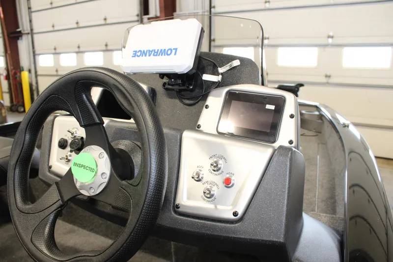 Slide: The Image of 2025 Tracker Pro Team 175 boat dashboard with steering wheel and electronic controls. - 7