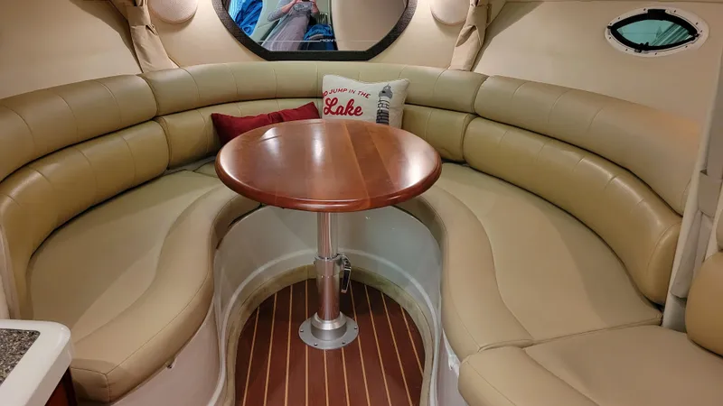 Slide: The Image of 2008 Monterey 315 Sport Yacht interior with beige seating and wooden table. - 10