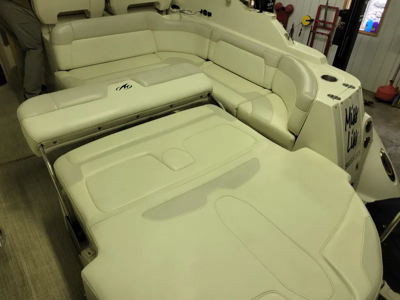 Slide: The Image of 2008 Monterey 315 Sport Yacht interior with beige leather seating in a spacious layout. - 16