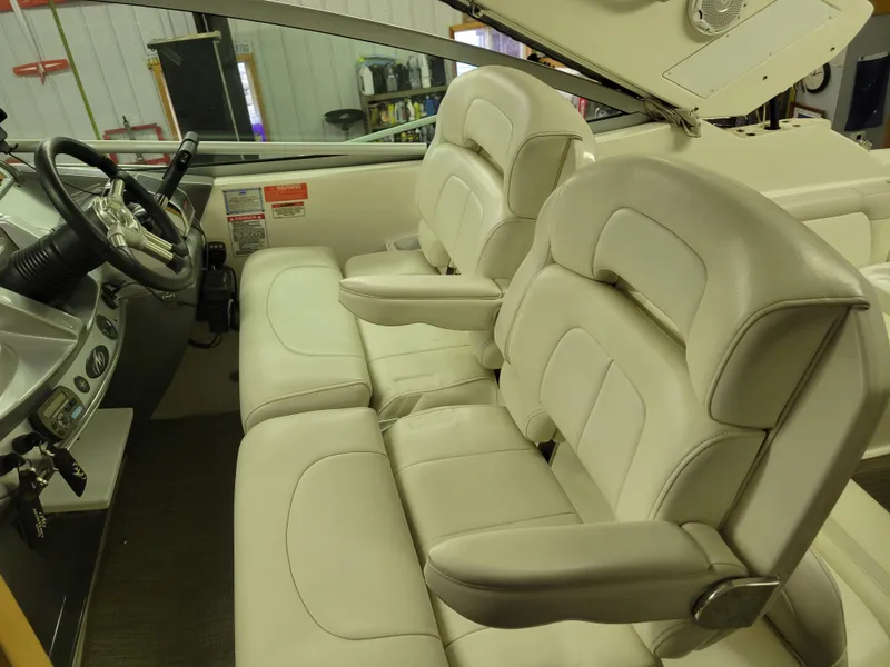 Slide: The Image of 2008 Monterey 315 Sport Yacht interior with plush white seating and modern dashboard. - 21