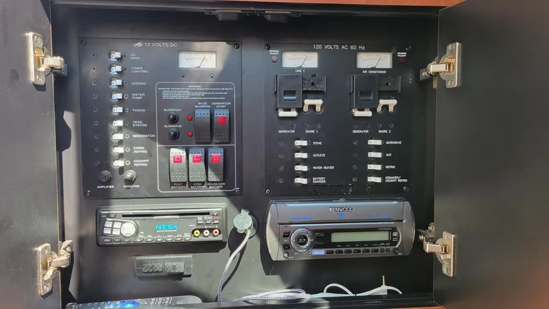 Slide: The Image of Electrical control panel of a 2008 Monterey 315 Sport Yacht with various switches and devices. - 23