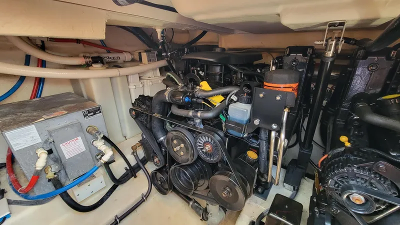 Slide: The Image of Engine room of a 2008 Monterey 315 Sport Yacht, showcasing mechanical components and wiring. - 25