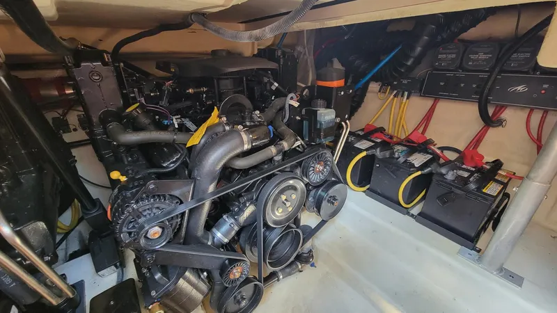 Slide: The Image of Engine room of 2008 Monterey 315 Sport Yacht with visible batteries and wiring. - 26
