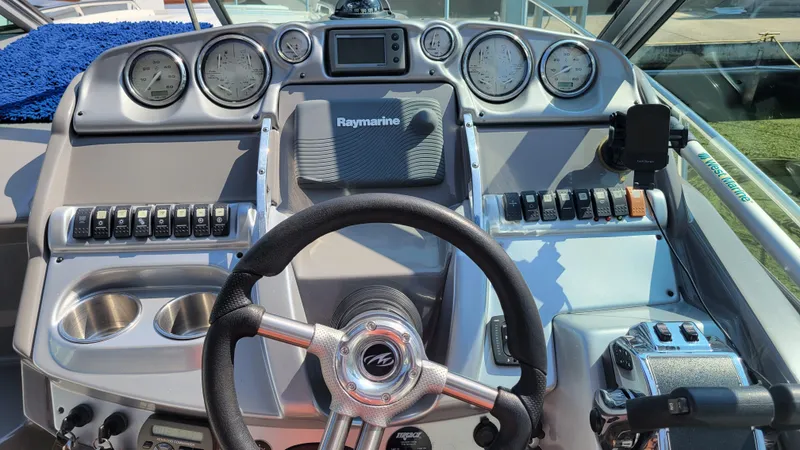 Slide: The Image of Dashboard of a 2008 Monterey 315 Sport Yacht with steering wheel and control panel. - 3