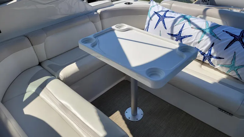 Slide: The Image of 2008 Monterey 315 Sport Yacht interior with cushioned seating and starfish-patterned pillow. - 6