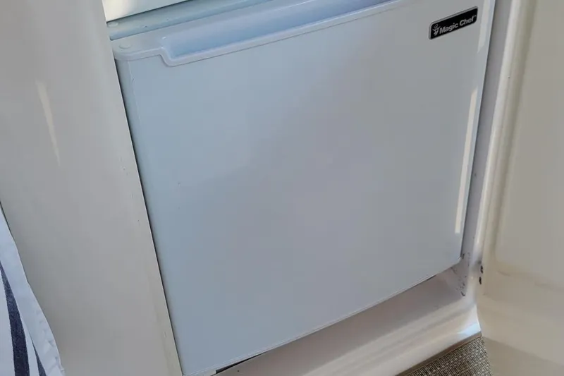 Slide: The Image of Compact fridge inside 2008 Monterey 315 Sport Yacht cabin. - 8