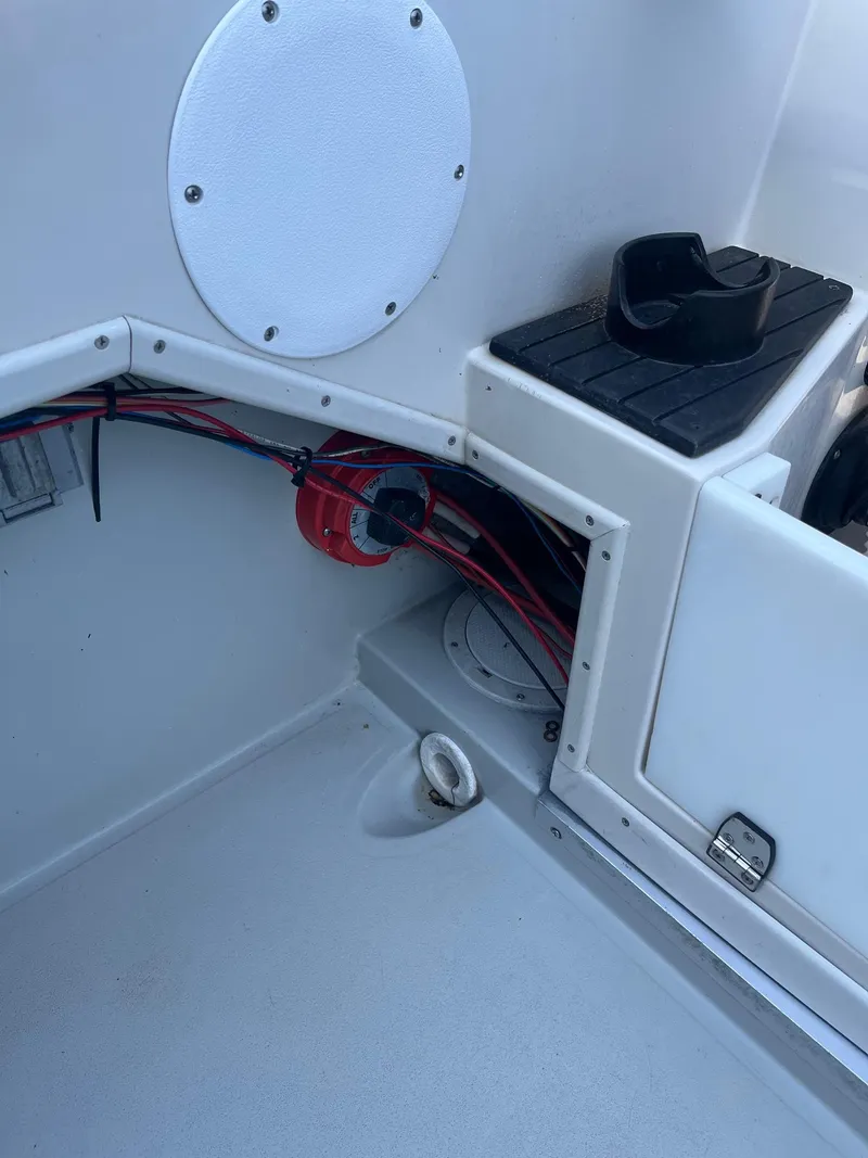 Slide: The Image of 1989 Wellcraft 250 Sportsman boat interior showing wiring and storage compartment. - 10