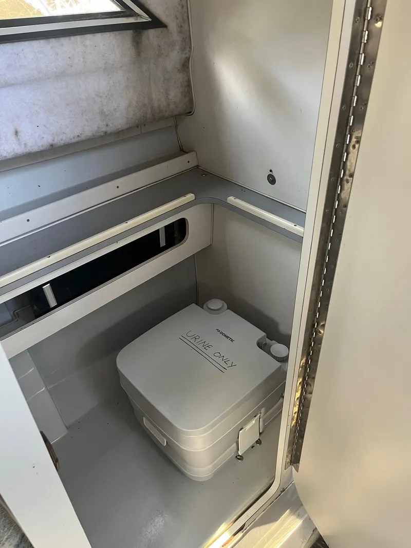 Slide: The Image of 1989 Wellcraft 250 Sportsman boat interior with portable toilet. - 5