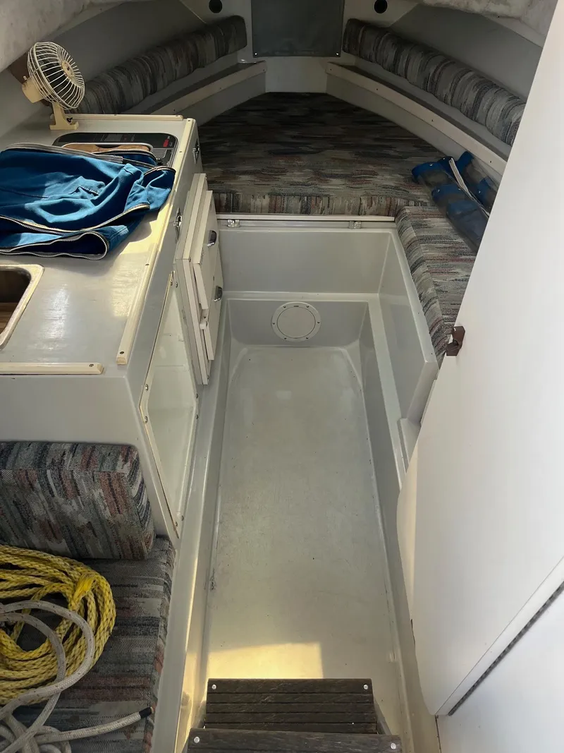 Slide: The Image of 1989 Wellcraft 250 Sportsman cabin interior with seating, storage, and nautical equipment. - 7