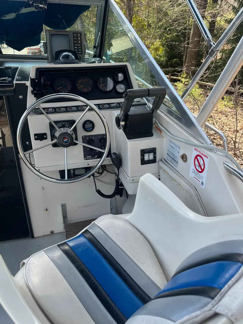Slide: The Image of 1989 Wellcraft 250 Sportsman boat cockpit with steering wheel and control panel. - 8