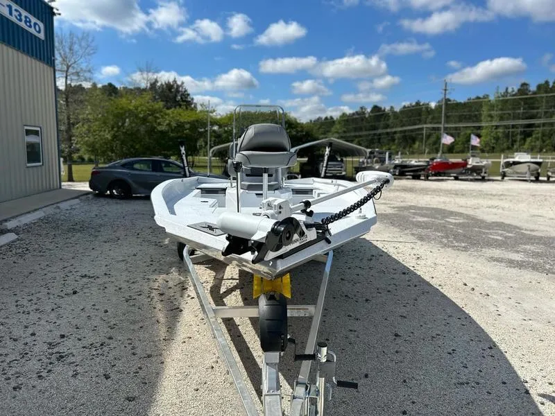 Slide: The Image of 2025 Xpress H22B boat on trailer, parked outdoors under a clear blue sky. - 1