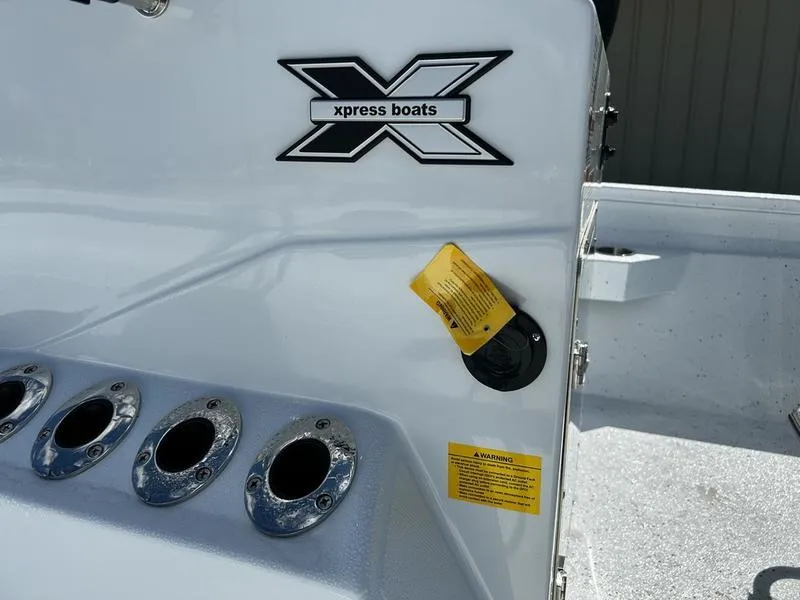 Slide: The Image of 2025 Xpress H22B boat console with logo and rod holders. - 10