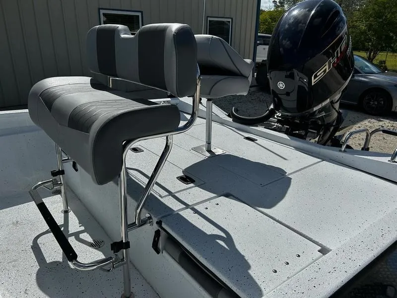Slide: The Image of 2025 Xpress H22B boat with dual gray seats and powerful outboard motor. - 11