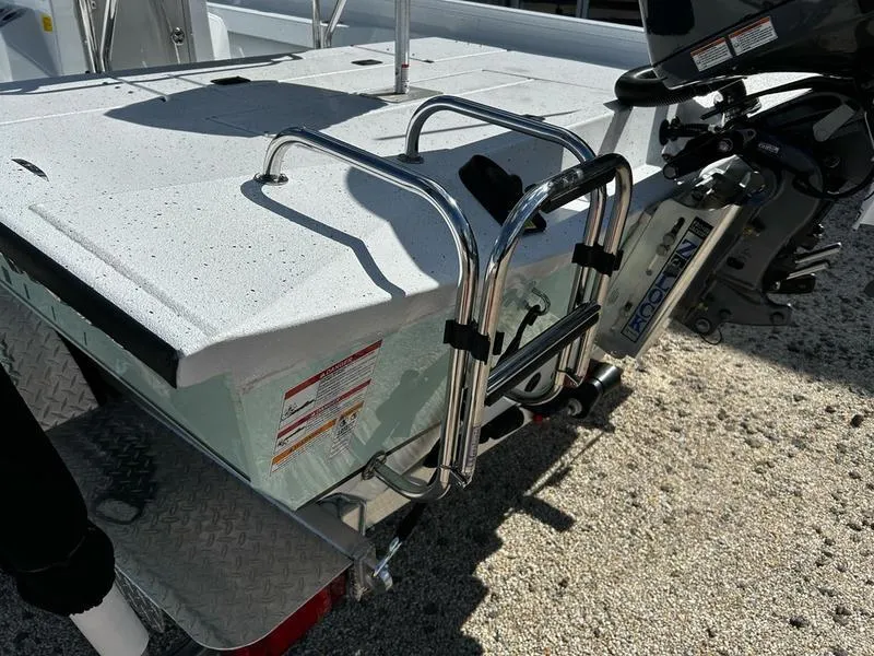 Slide: The Image of 2025 Xpress H22B boat with ladder and motor on a trailer. - 16