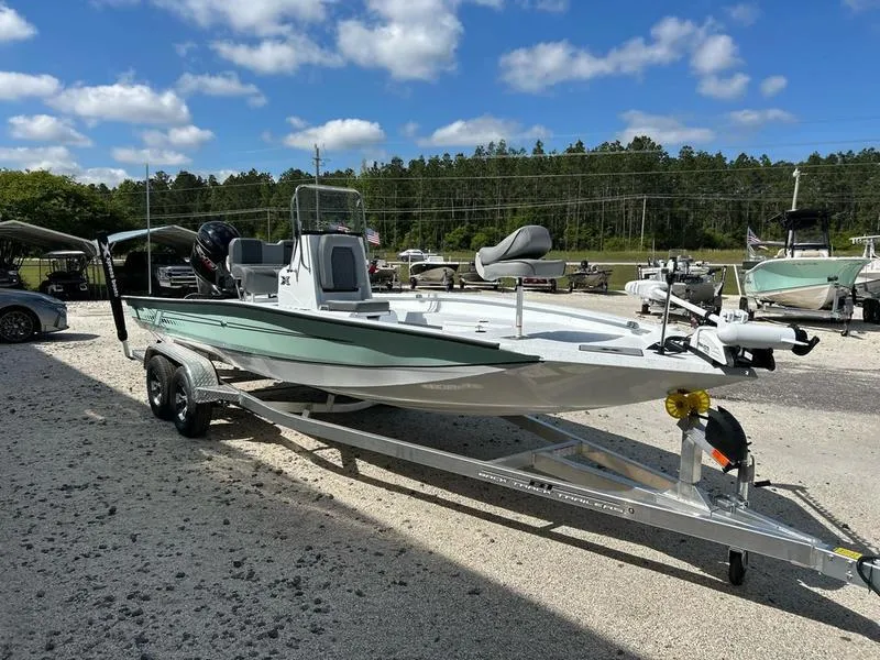 Slide: The Image of 2025 Xpress H22B boat on trailer, parked outdoors under a blue sky. - 3