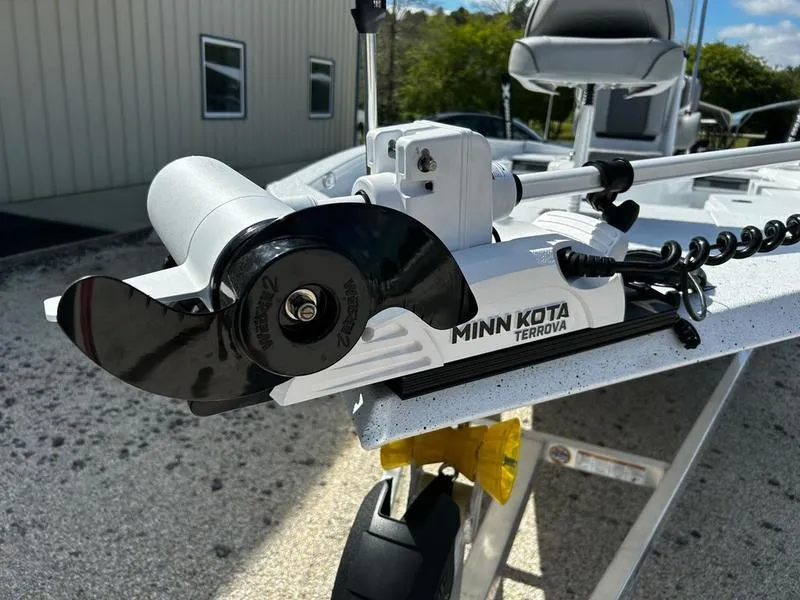 Slide: The Image of 2025 Xpress H22B boat with Minn Kota Terrova trolling motor, parked outdoors. - 9