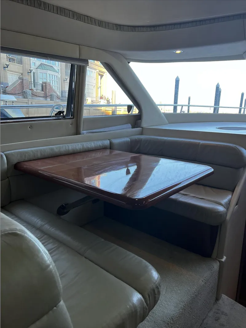 Slide: The Image of Luxurious interior of 2002 Sea Ray 56 Sedan Bridge yacht with elegant dining area. - 10
