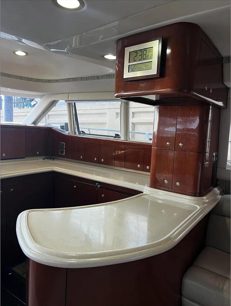 Slide: The Image of Luxurious interior of 2002 Sea Ray 56 Sedan Bridge yacht with elegant wood cabinetry. - 13