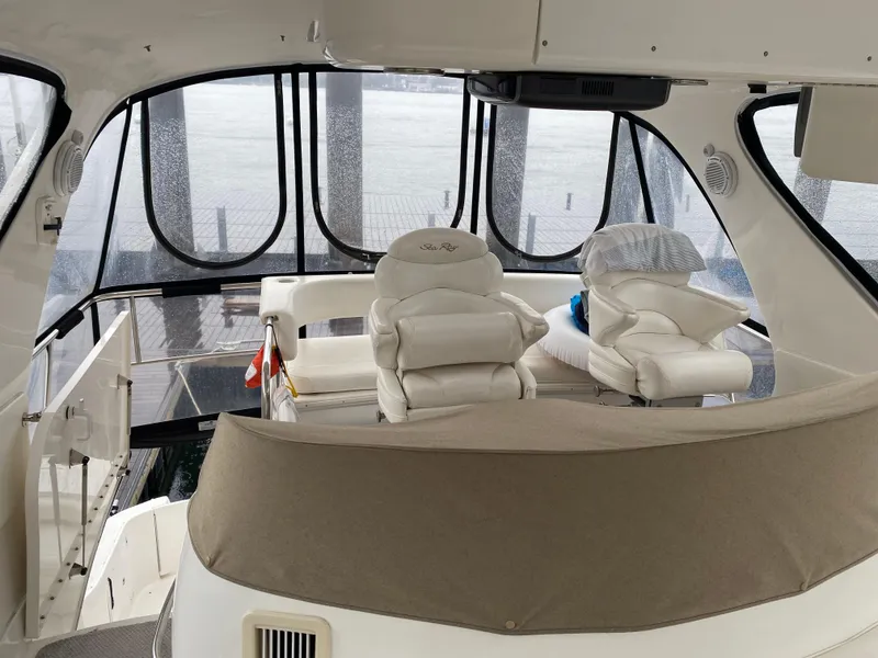 Slide: The Image of 2002 Sea Ray 56 Sedan Bridge interior with helm and seating area. - 16