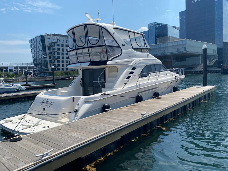 Slide: The Image of 2002 Sea Ray 56 Sedan Bridge yacht docked in urban marina setting. - 2