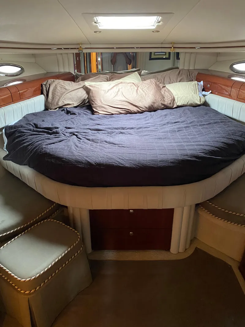 Slide: The Image of Luxurious 2002 Sea Ray 56 Sedan Bridge cabin with cozy bed and elegant decor. - 22