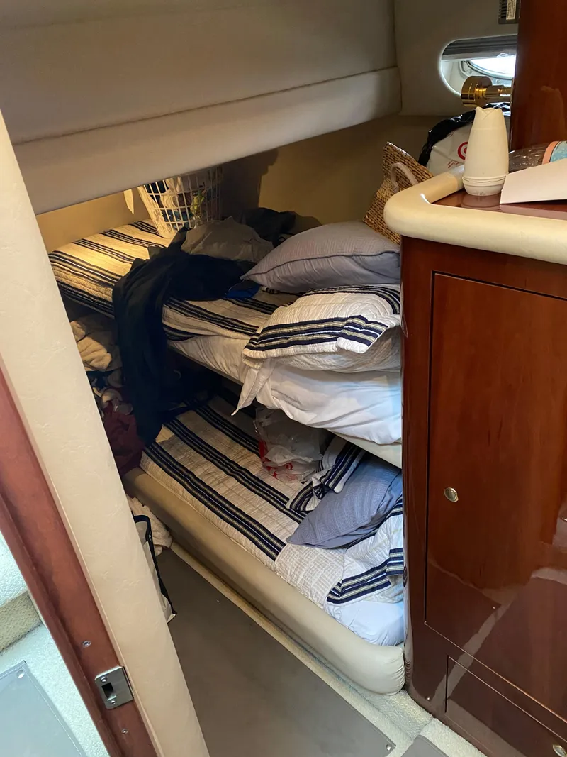 Slide: The Image of Interior cabin of 2002 Sea Ray 56 Sedan Bridge with bunk beds and wooden cabinetry. - 24