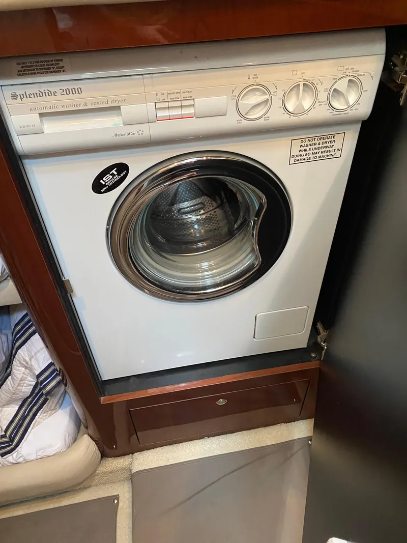 Slide: The Image of Washer-dryer unit inside 2002 Sea Ray 56 Sedan Bridge yacht. - 25