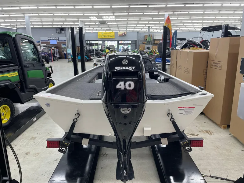 Slide: The Image of 2025 Lowe Skorpion 16 boat with Mercury 40 engine displayed indoors. - 4