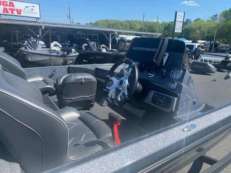 Slide: The Image of Nitro Z20 Pro 2022 boat interior with steering wheel and Humminbird electronics. - 2