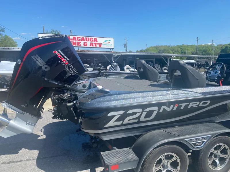 Slide: The Image of 2022 Nitro Z20 Pro boat with powerful engine, parked outdoors under clear blue sky. - 3