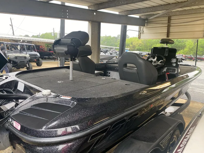 Slide: The Image of 2022 Nitro Z20 Pro bass boat under a covered area, showcasing sleek design and seating. - 5