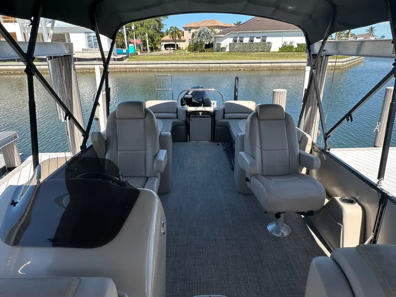 Slide: The Image of 2020 Avalon Catalina Platinum Quad Lounger boat interior with luxurious seating and waterfront view. - 10