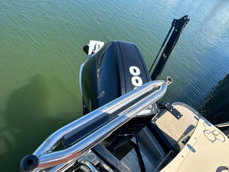 Slide: The Image of 2020 Avalon Catalina Platinum Quad Lounger boat with powerful outboard motor on calm water. - 14