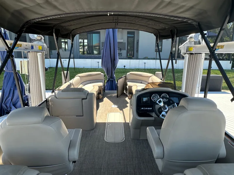 Slide: The Image of 2020 Avalon Catalina Platinum Quad Lounger interior with seating and steering console. - 16